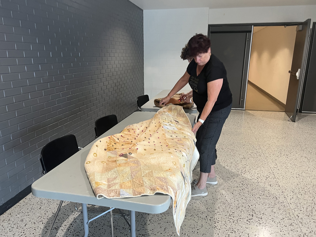 Festival installer: Freda preparing the Time installation ready for hanging, World of Threads Festival 2023-24.