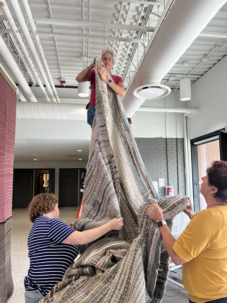 Festival installers: Melissa, Caren and Freda installing the Time installation, World of Threads Festival 2023-24.