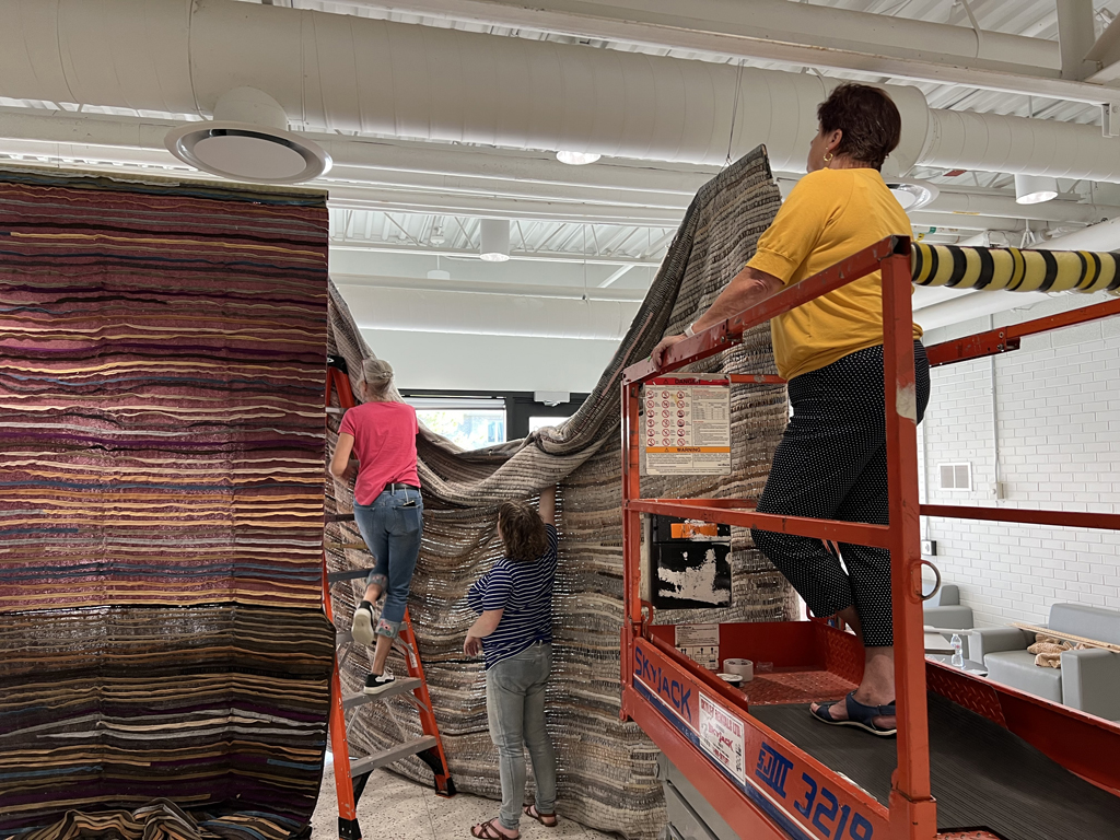Festival installers: Caren, Melissa and Freda installing the Time installation, World of Threads Festival 2023-24.