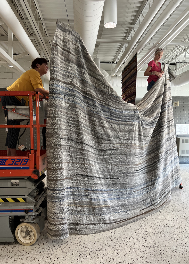 Festival installers: Freda and Caren installing the Time installation, World of Threads Festivsl 2023-24.