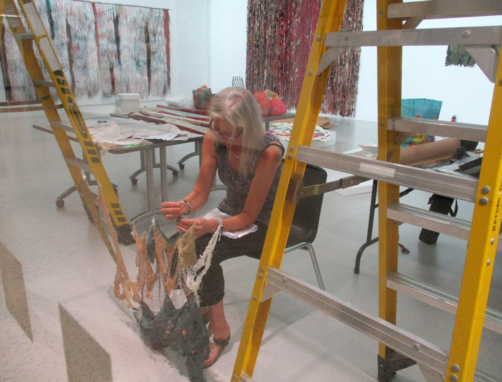 Festival installer Caren setting up to install artwork.