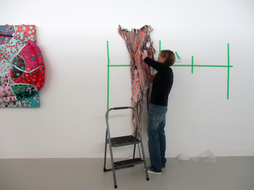 Artist Margery starting to install her artwork. 