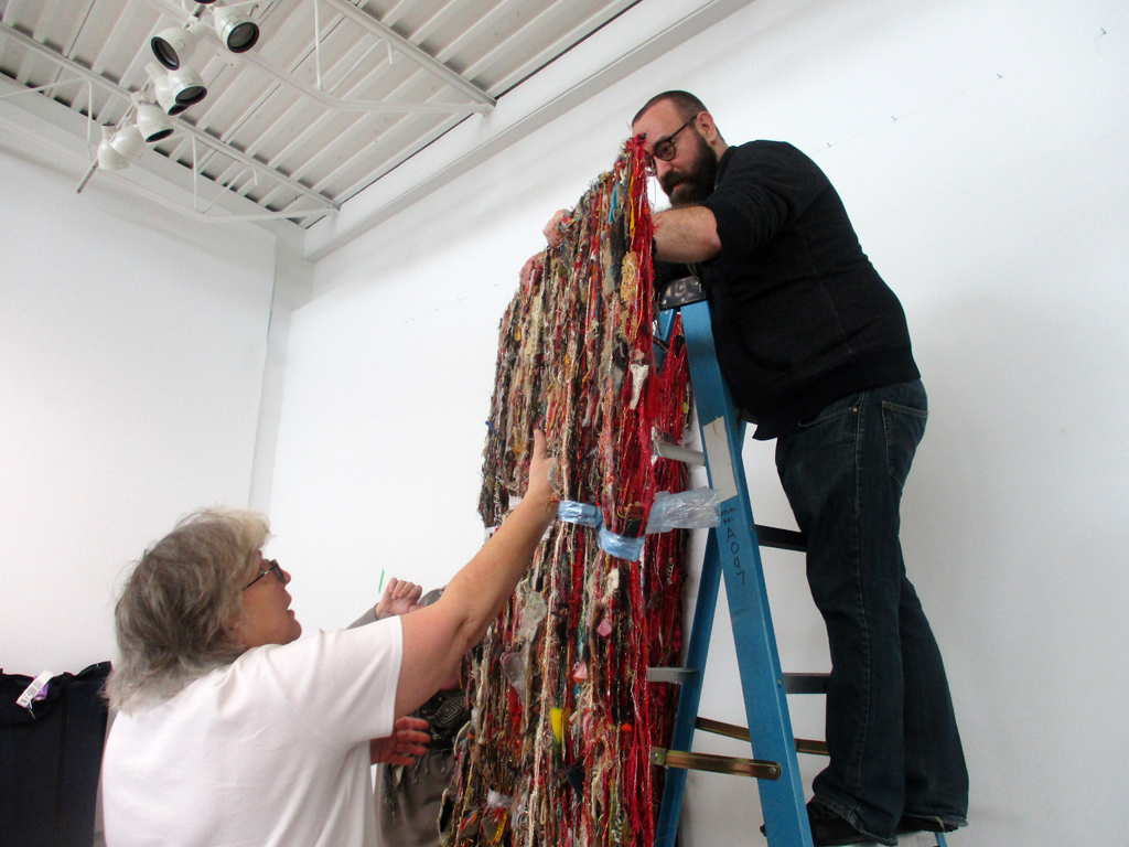 Festival installer Jeanne and Festival Curator Gareth Bate, taking down artwork at the end of the festival.