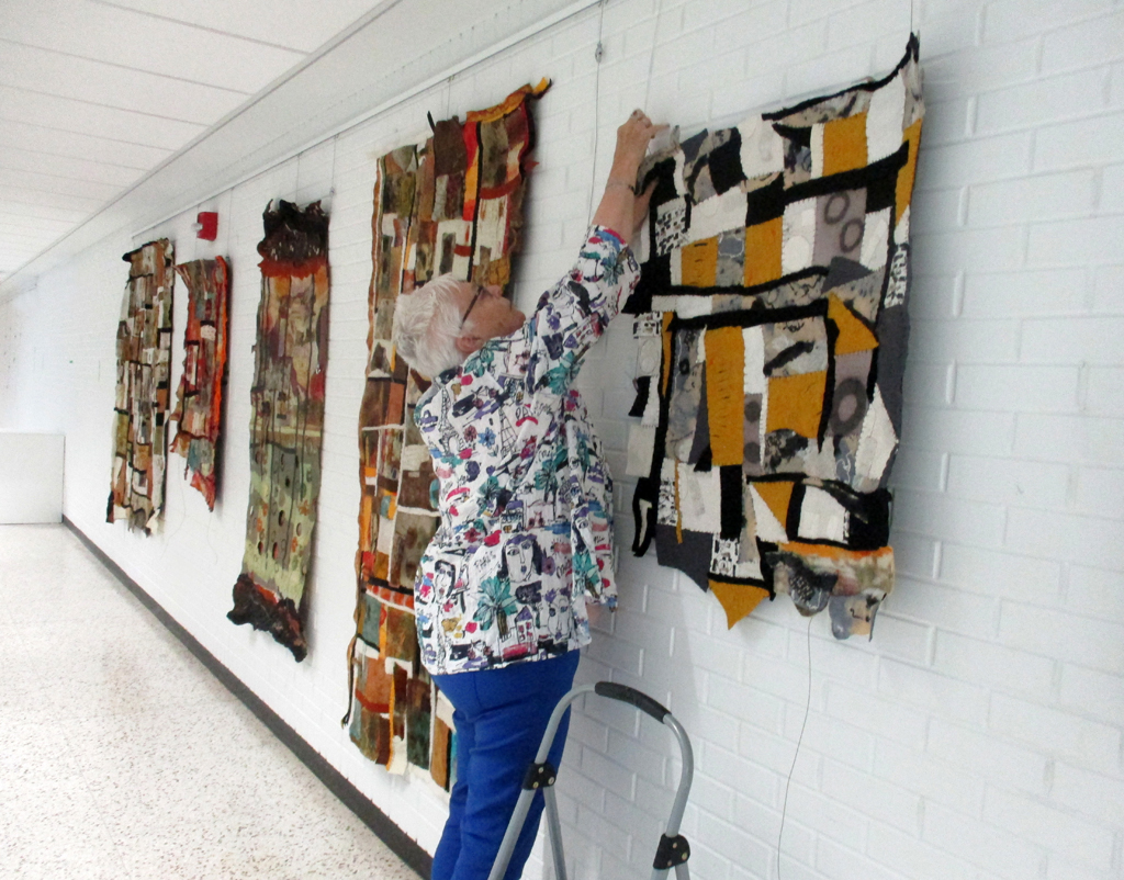 Festival Installer: Chris, installing work by Denise Kooperman, Solo Shows, World of Threads Festival 2023-24.