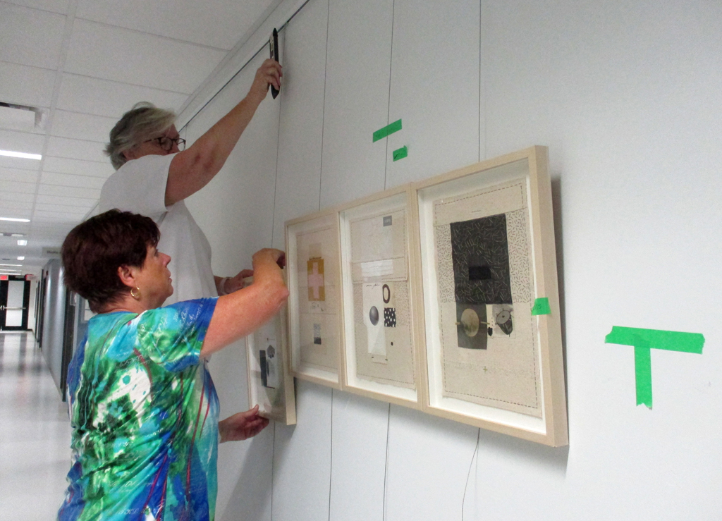 Festival Installers: Freda and Jeanne, installing artwork of Marla Panko, Solo Shows, World of Threads Festival 2023-24.