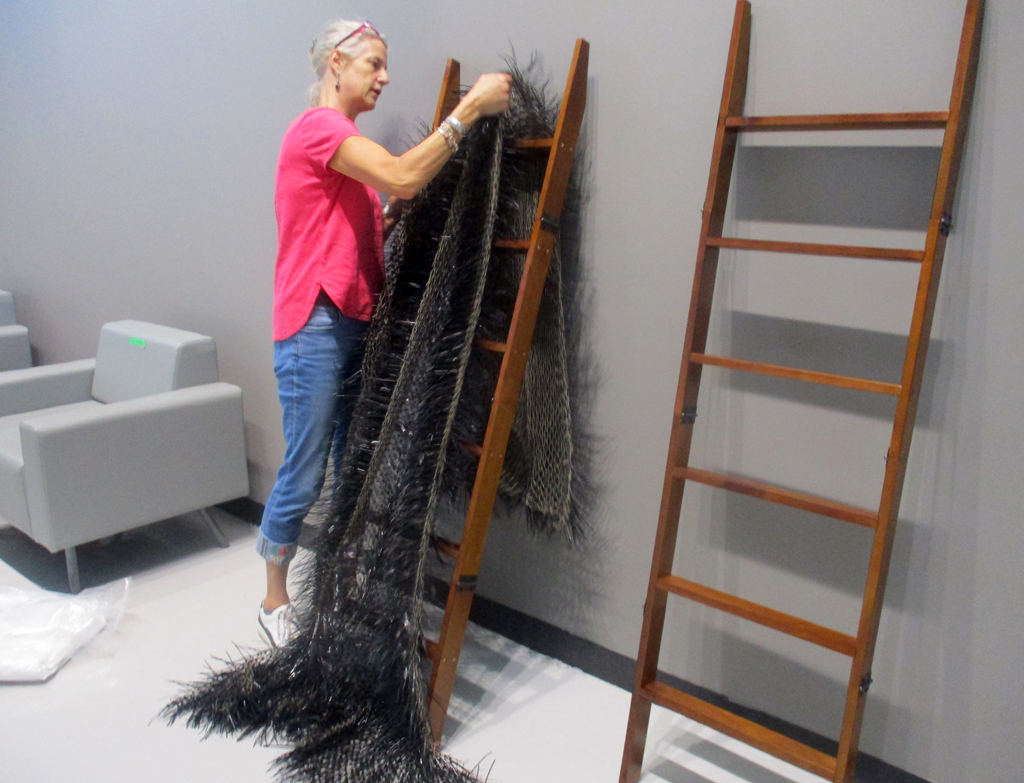 Festival Installer: Caren, installing Blackity Black Blanket, World of Threads Festival 2023-24.