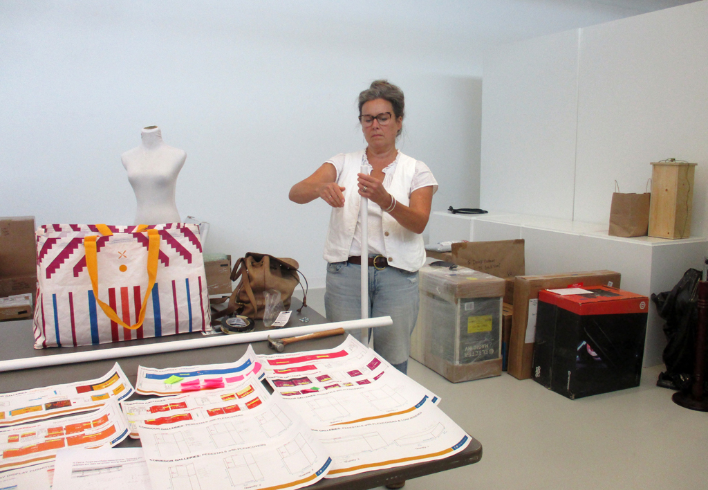 Artist: Carolyn Murphy installing her work, Solo Shows, World of Threads Festival 2023-24. 