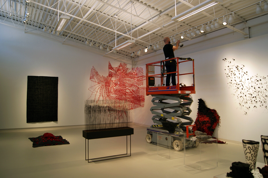 Doing the lighting for The Red and the Black exhibition, World of Threads Festival 2014.