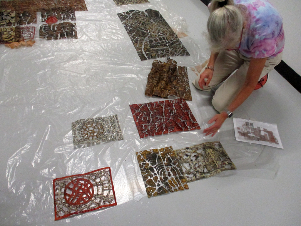 Festival installer: Caren installing artwork by Eszter Bornemisza, Solo Shows, World of Threads Festival 2023-24.