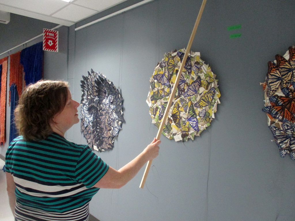Festival Installer: Melissa installing artwork of Lorna Livey, Solo Shows, World of Threads Festival 2023-24.