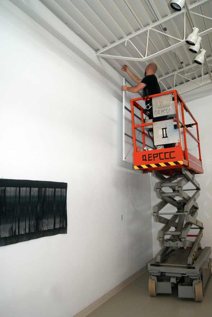 Doing the lighting for The Red and the Black exhibition, World of Threads Festival 2014.