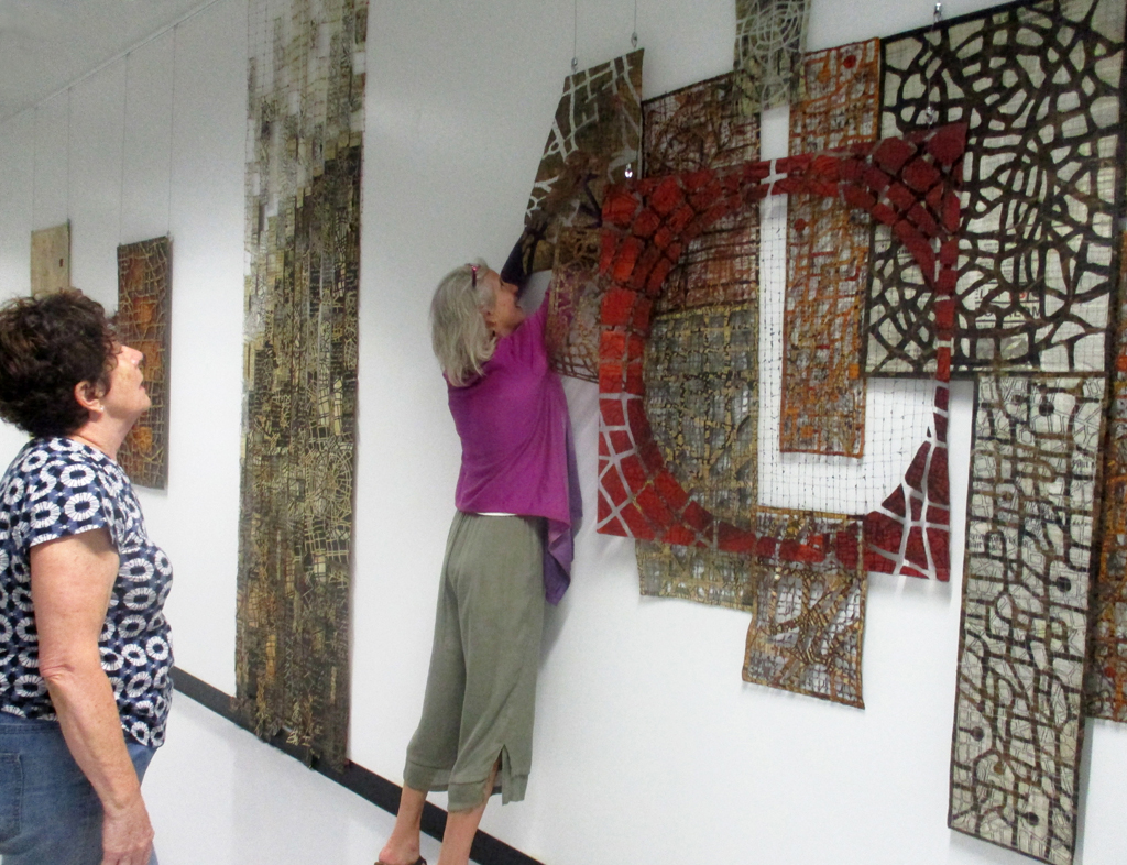 Festival installer: Caren installing artwork by Eszter Bornemisza, Solo Shows, World of Threads Festival 2023-24.