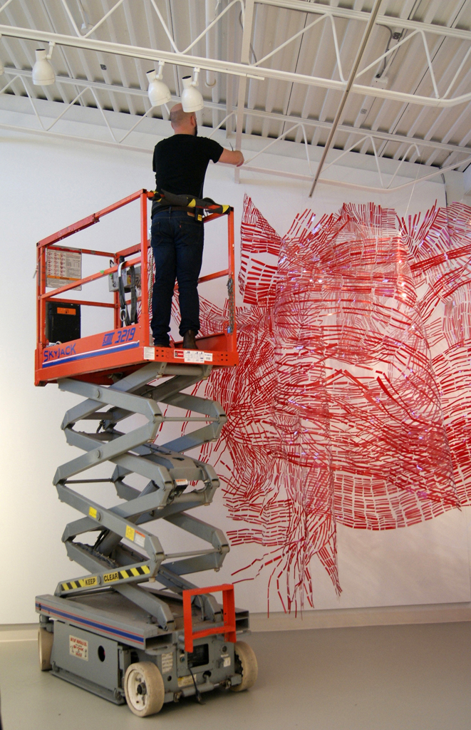 Installing artwork for The Red and the Black exhibition, World of Threads Festival 2014.