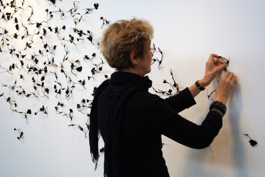 Artist: Gordana Olujic Dosic, installing her artwork, The Red and the Black exhibition, World of Threads Festival 2014.