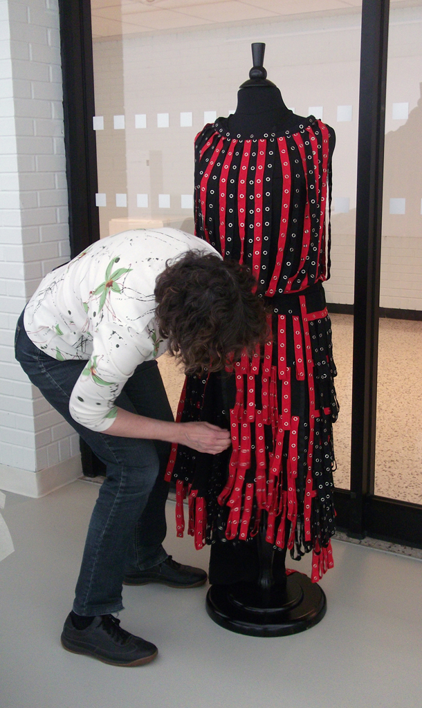 Installing the artwork of Leisa Rich, The Red and the Black exhibition, World of Threads Festival 2014.