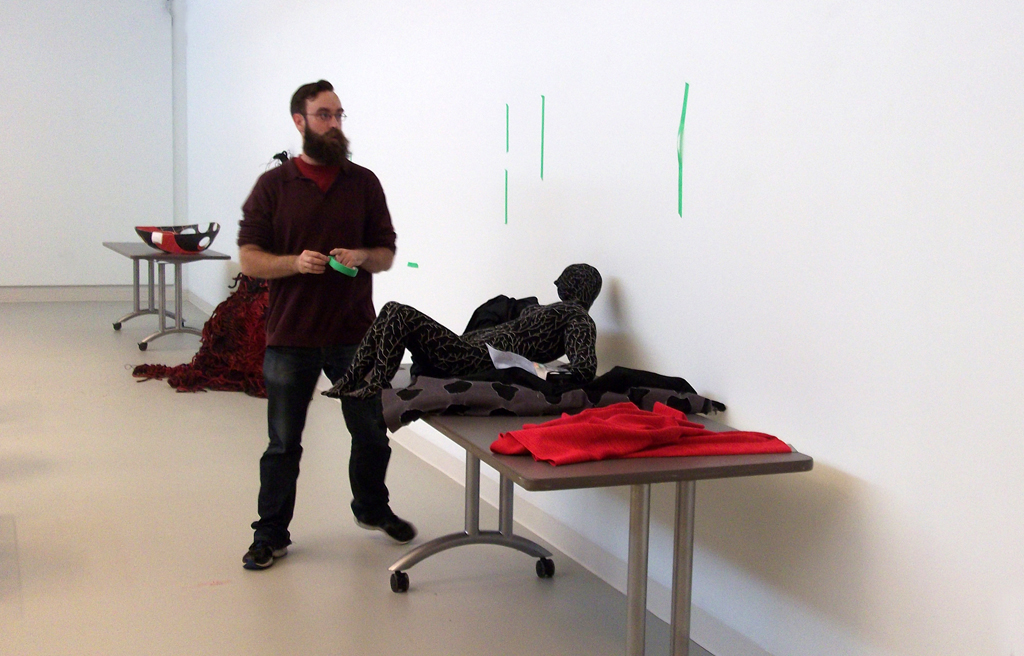 Festival Curator: Gareth installing artwork for The Red and the Black exhibition, World of Threads Festival 2014.