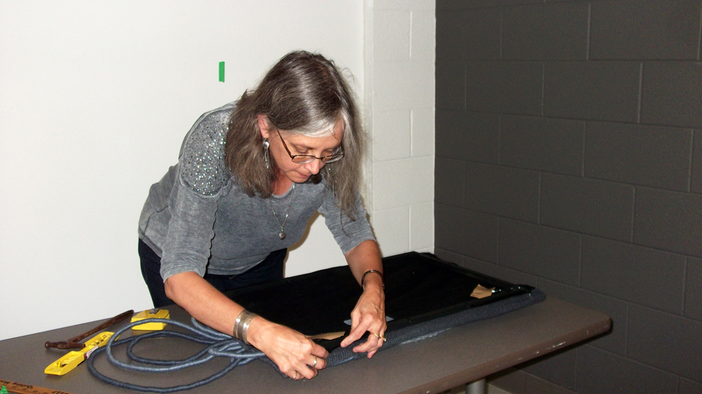 Festival installer: Ruth, installing artwork for The Red and the Black exhibition, World of Threads Festival 2014.
