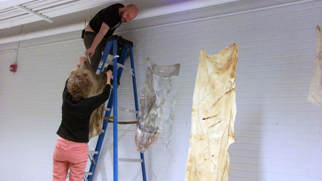 Artist: Pat Loucks helping to install her work, Installations, World of Threads Festival 2014.