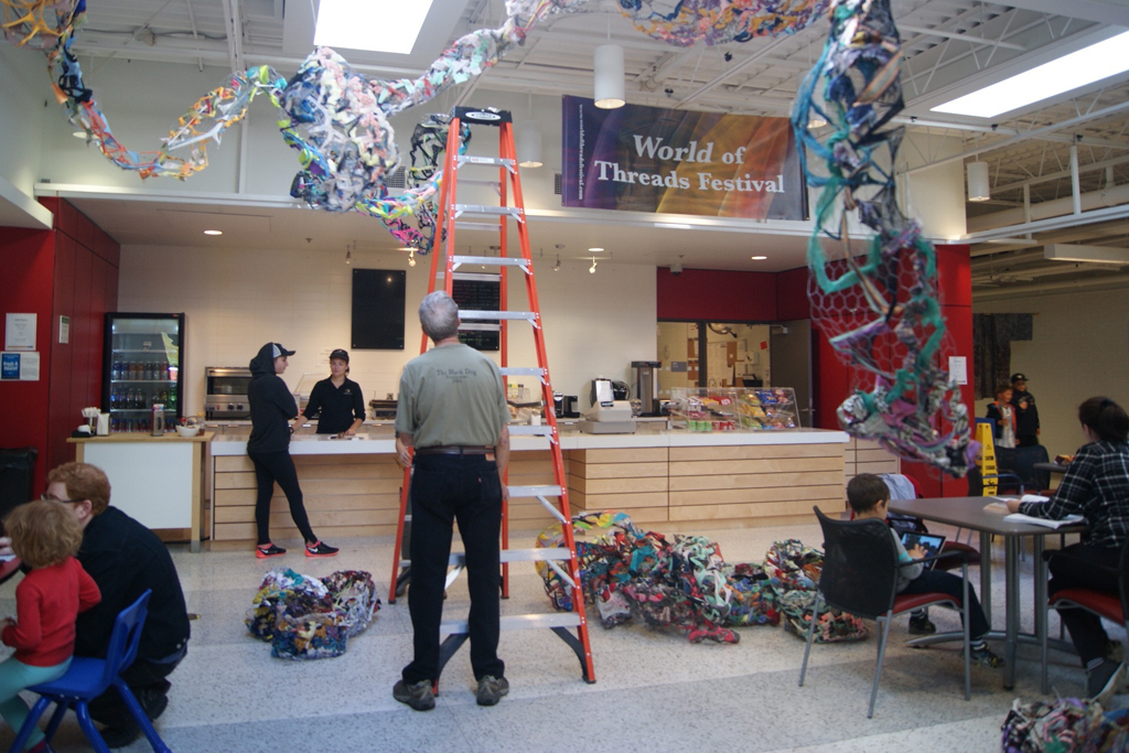 Dad, Mr Tripp Morrow, installing art installation by Olivia, World of Threads Festival 2016.