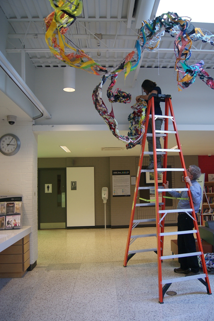Artist: Olivia Tripp Morrow installing her art installation, World of Threads Festival 2016.