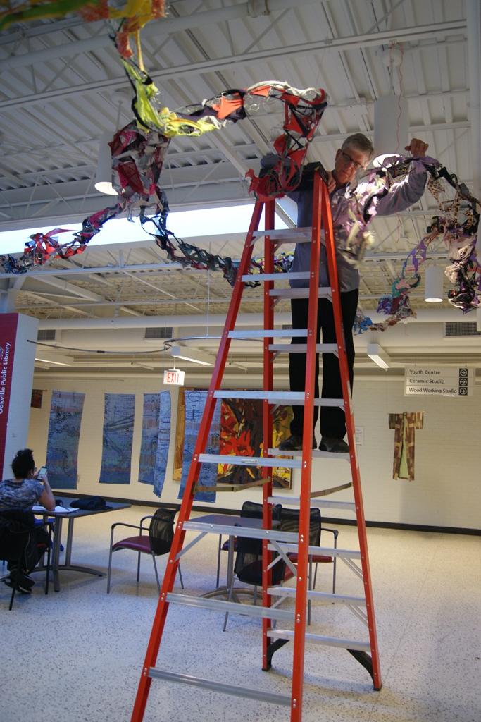 Dad, Mr Tripp Morrow, installing art installation by Olivia, World of Threads Festival 2016.
