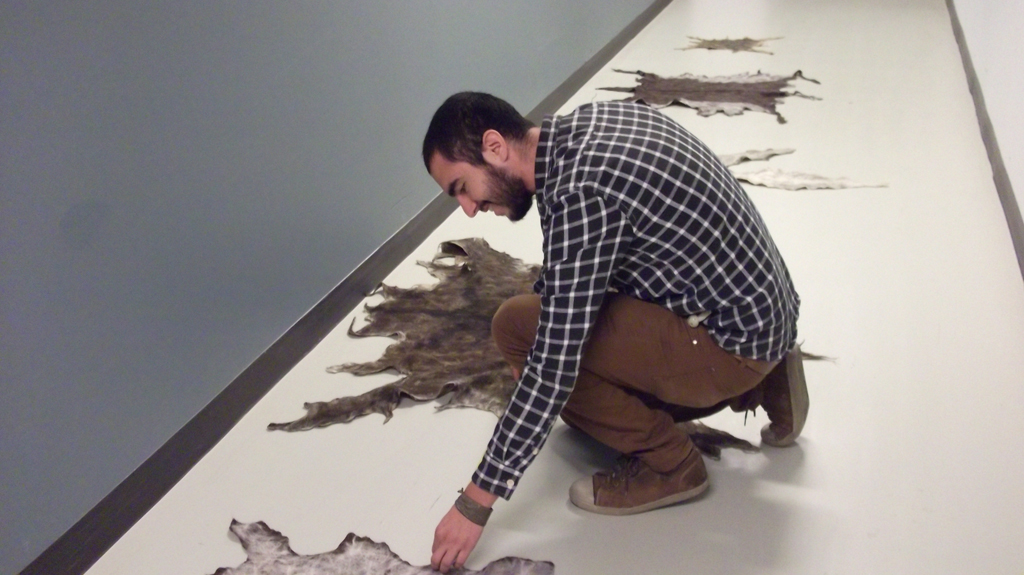 Artist: Daniel F Manchego, Installing his installation, World of Threads Festival 2014.